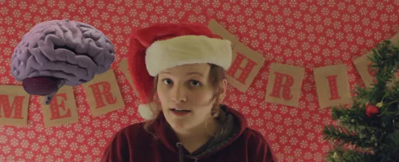 Iris wearing a Santa hat alongside a picture of a brain