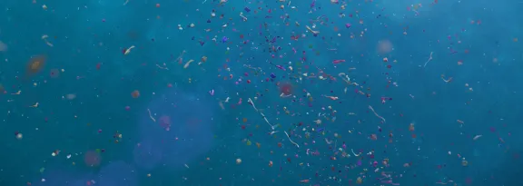 3D render of nurdles and micro plastic particles in ocean water