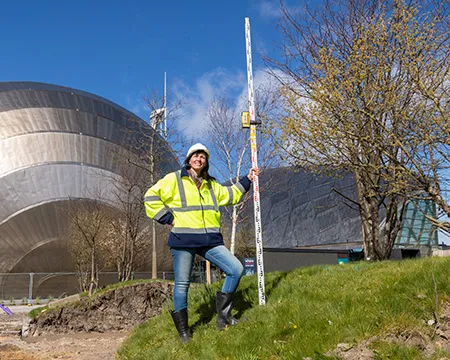 Dr Gillian Lang in a hard hat as ground is broken on work around the outside of Glasgow Science Centre