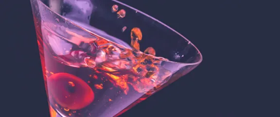 close up of cocktail with cherry in it 