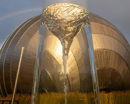 A whirlpool in a container in front of a silver-coloured metal building. Image: Paul Upward and Timberplay Scotland