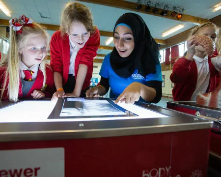 pupils and science communicator at exhibit