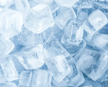 Crystal clear ice cubes as background, top view