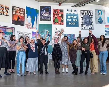 A group photo of the 'Climate Sisters' and Community Learning team outside The Bothy at Glasgow Science Centre. Photo: Sandy Young.