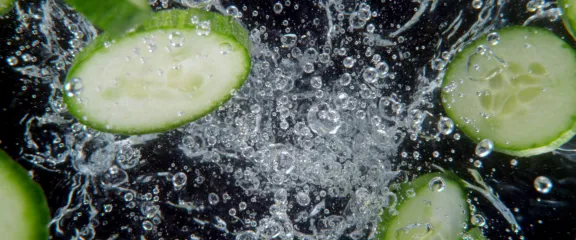cucumber floating in fizzy liquid 