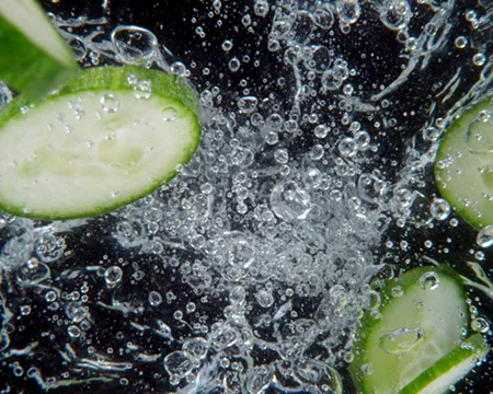 A close-up of gin and cucumber in a glass