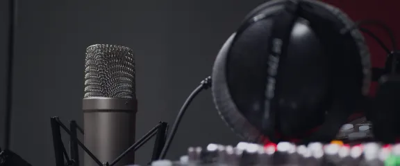 A microphone, mixing desk and headphones