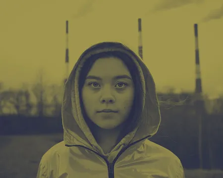 a headshot of a young person looking directly at the camera, the image is tinted yellow