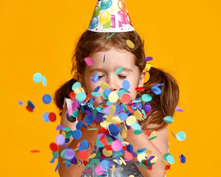girl with confetti in party hat 