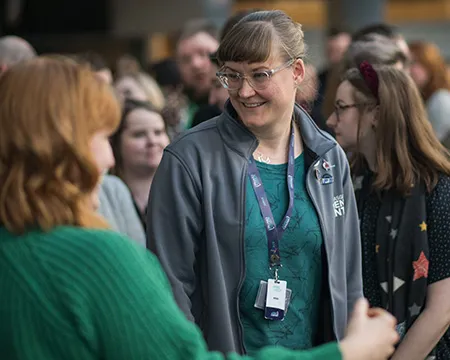 A smiling staff member amongst a group at a team building event