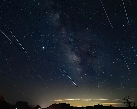 Perseids meteor shower over a city