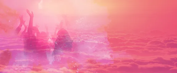 People are seen dancing on a cloudscape through a pink and orange haze