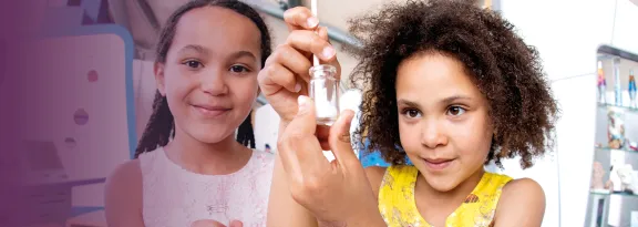 Two children mix a cotton swab in a test tube