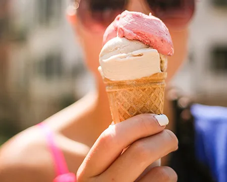 An ice cream being held up in front of a face