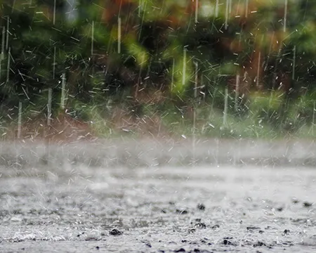 Rain bouncing off the surface of a road