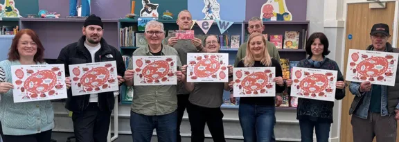 Meet Me in Govan participants holding copies of the map