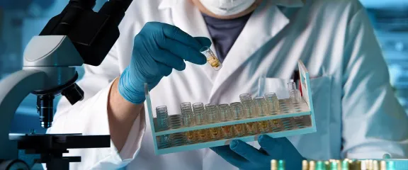 scientist working with sample for analysis in microscope in the lab