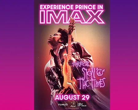 Prince posing with guitar.