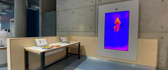 A display shows an infra-red image of a human interacting at an exhibit
