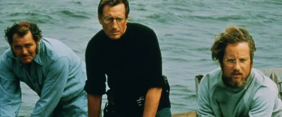 Jaws - Three men on a boat look out towards the threat in the water