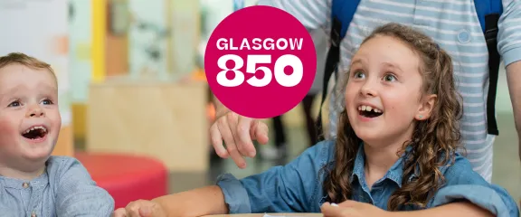 Two children excitedly play with one of the exhibits. Their mouths agape and eyes wide in wonder.
