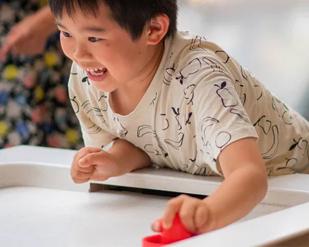 Child plays with the air hockey table