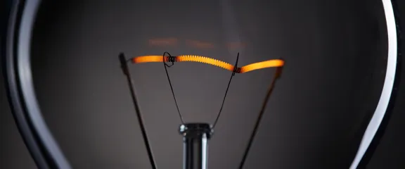 the filament in a lightbulb glows orange