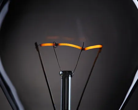 the filament in a lightbulb glows orange