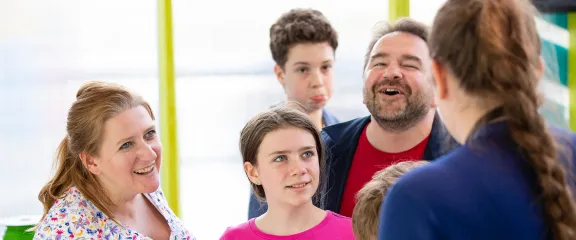 An expert engages a family group with their research