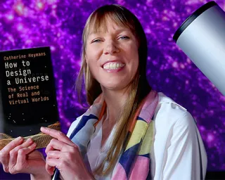 Prof Catherine Heymans holding up her book 