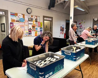 Adults explore and interact with the forensic science exhibits