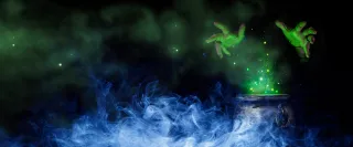 An eerie green glow lights up a witch's hand over a cauldron