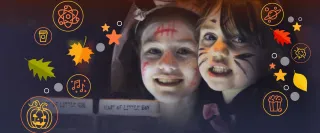 Two young girls wearing facepaint smile