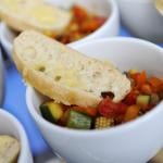 Bowl of Mediterranean vegetables and a slice of bread