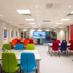 The classroom space with colourful chairs and tables at Newton Flight Academy