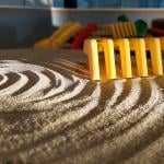 The Sand Table. A rotating disc with sand on it. The sand has a raked pattern of concentric circles on it.