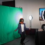 A visitor becomes an astronaut against a green screen backdrop