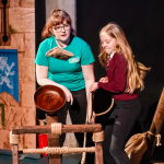 Science Communicator demonstrates the catapult to a child