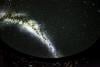 The Milky Way galaxy stretches over the heads of a Planetarium audience.