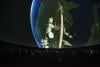 The International Space Station and Earth move into view above a Planetarium audience.
