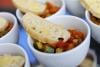 Bowl of Mediterranean vegetables and a slice of bread