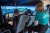School pupils and flight instructors flying in flight simulator