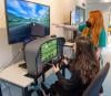 A pupil and flight instructor practice takeoff at a flight simulator