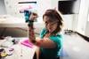 A science communicator with her face painted flexes her arm muscles