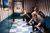 Three women in the wacky salon appear to be struggling to balance on what looks like level flooring