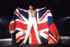 Freddie Mercury on stage with a Union Jack Flag