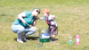 Science communicator blows bubbles with child