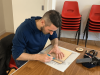 person using a ruler to draw a line onto a piece of wood