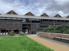 The Hidden Gardens Building, the roof has 4 peaks and the building is grey in colour