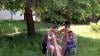 Musicians play under the shade of the trees